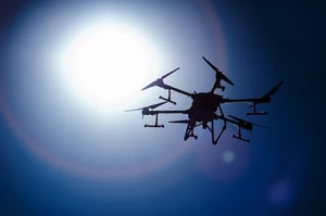 drone silhouette in front of the sun