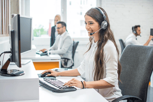 Woman with headset sitting in contact center