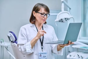 doctor-dentist-working-office-using-laptop-making-video-call-conference