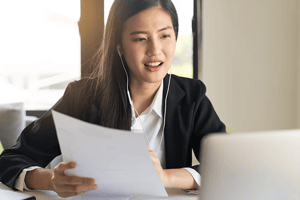 Woman holding cv in video call