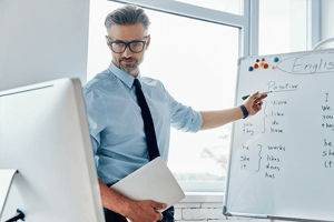 Teacher in front of whiteboard presenting online