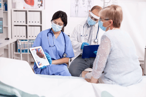 Doctor shows patient information on tablet