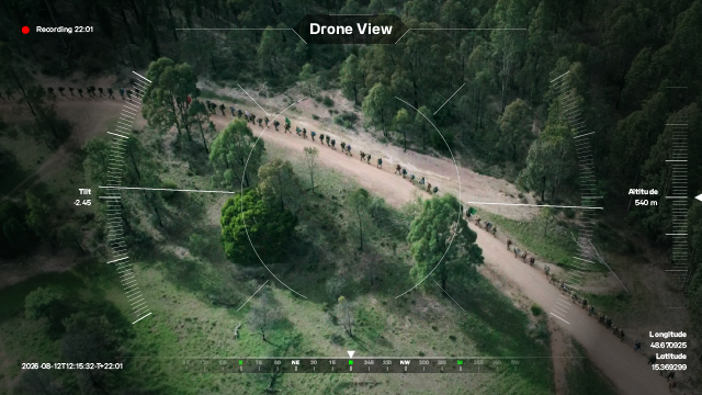 pov of a drone over marching troops in a forest